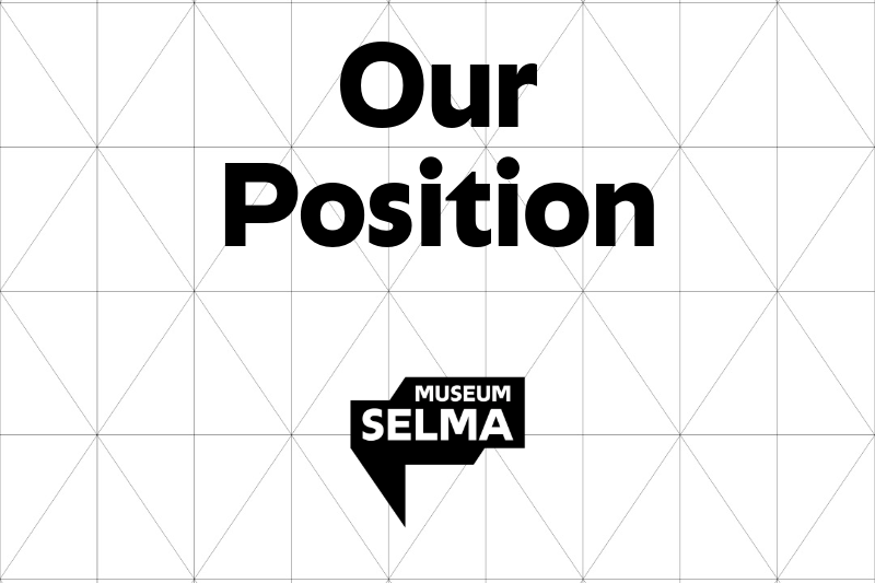 The museum logo and the words: Our Position, standing on a grid pattern.