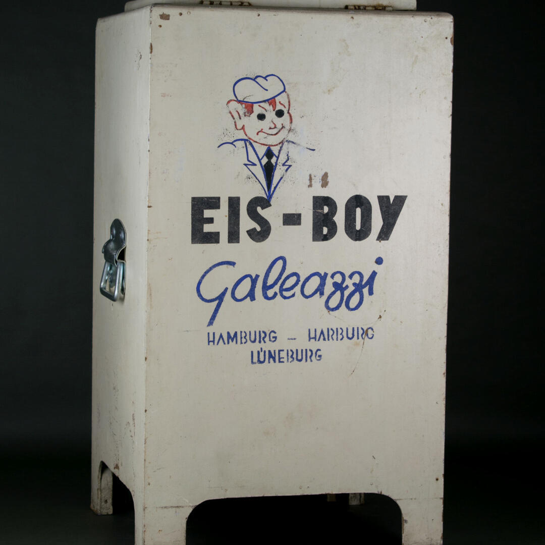 An old refrigerator with a picture of a person on it. It also says ‘Ice Boy’ on it and ‘Galeazzi’ underneath.