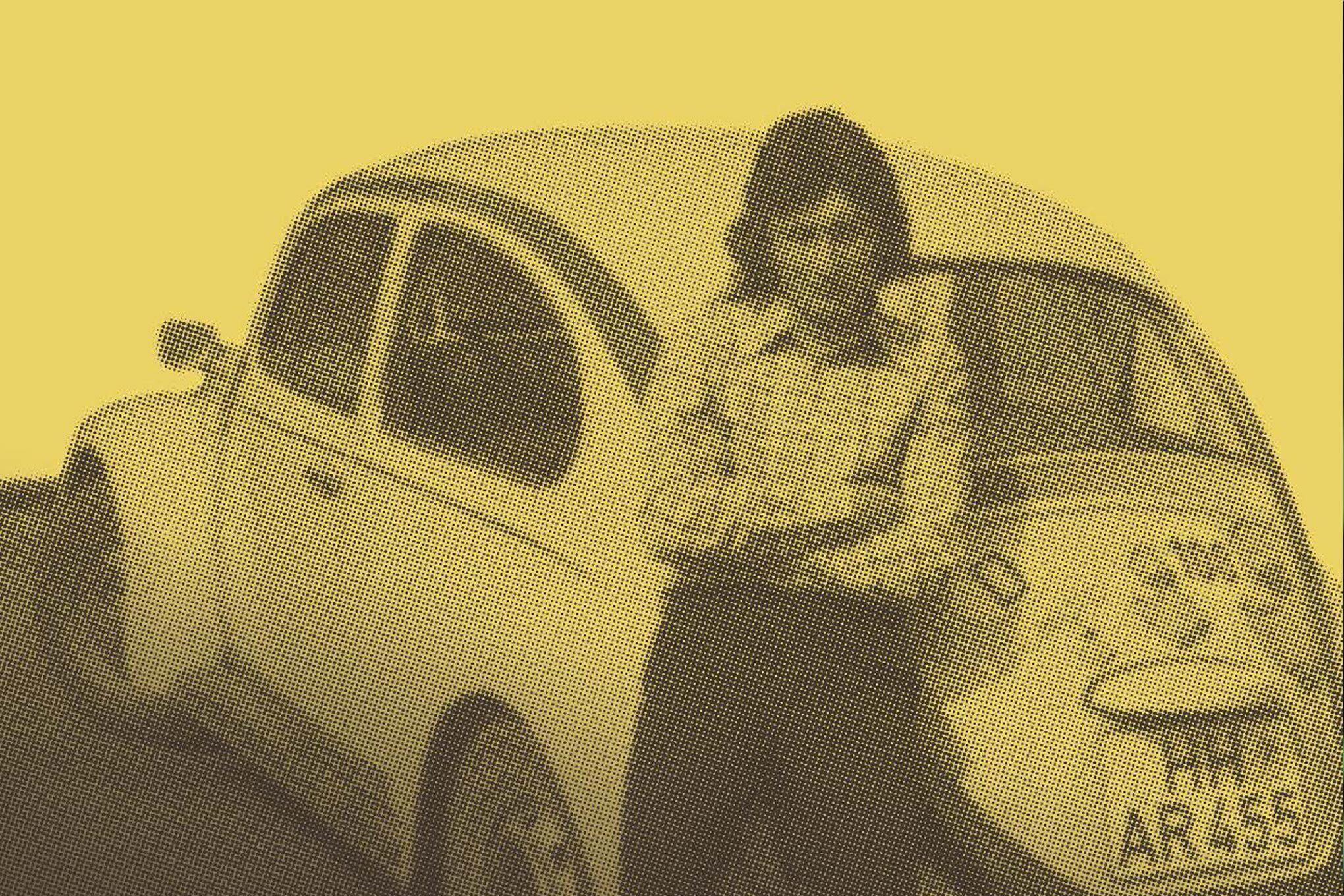 In the photo you can see a man standing in front of a car. He is leaning against the car with his arms closed. The car has a german licence plate and a lot of stickers on it.